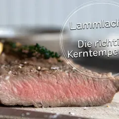 Perfekt gegarter Lammachs mit zarter rosa Kerntemperatur, garniert mit Knoblauch und Kräutern.