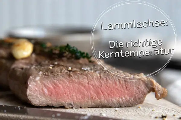 Perfekt gegarter Lammachs mit zarter rosa Kerntemperatur, garniert mit Knoblauch und Kräutern.